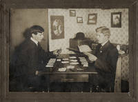 Photograph of two young men playing cards and smoking cigars, with an unsigned manuscript poem about the card game on the verso in early autograph ink