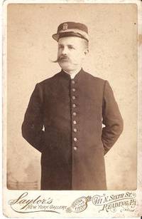 CABINET CARD PHOTO OF CONDUCTOR IN UNIFORM AND HAT WITH BRAID AND COMPANY BADGE: