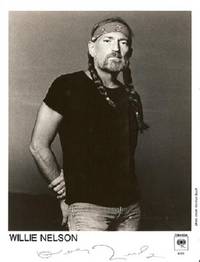 SIGNED PHOTOGRAPH, 8" x 10" black-and-white of Willie Nelson in bandanna-headband and pigtails, looking intently into the camera