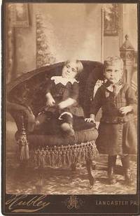 CABINET CARD PHOTO OF A TODDLER IN AN ELABORATE VICTORIAN CHAIR, AND A STANDING YOUNG BOY: