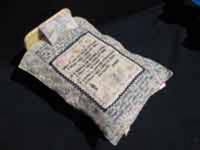 A Very Safe Place. Vintage Doll Bed with Embroidered Texts