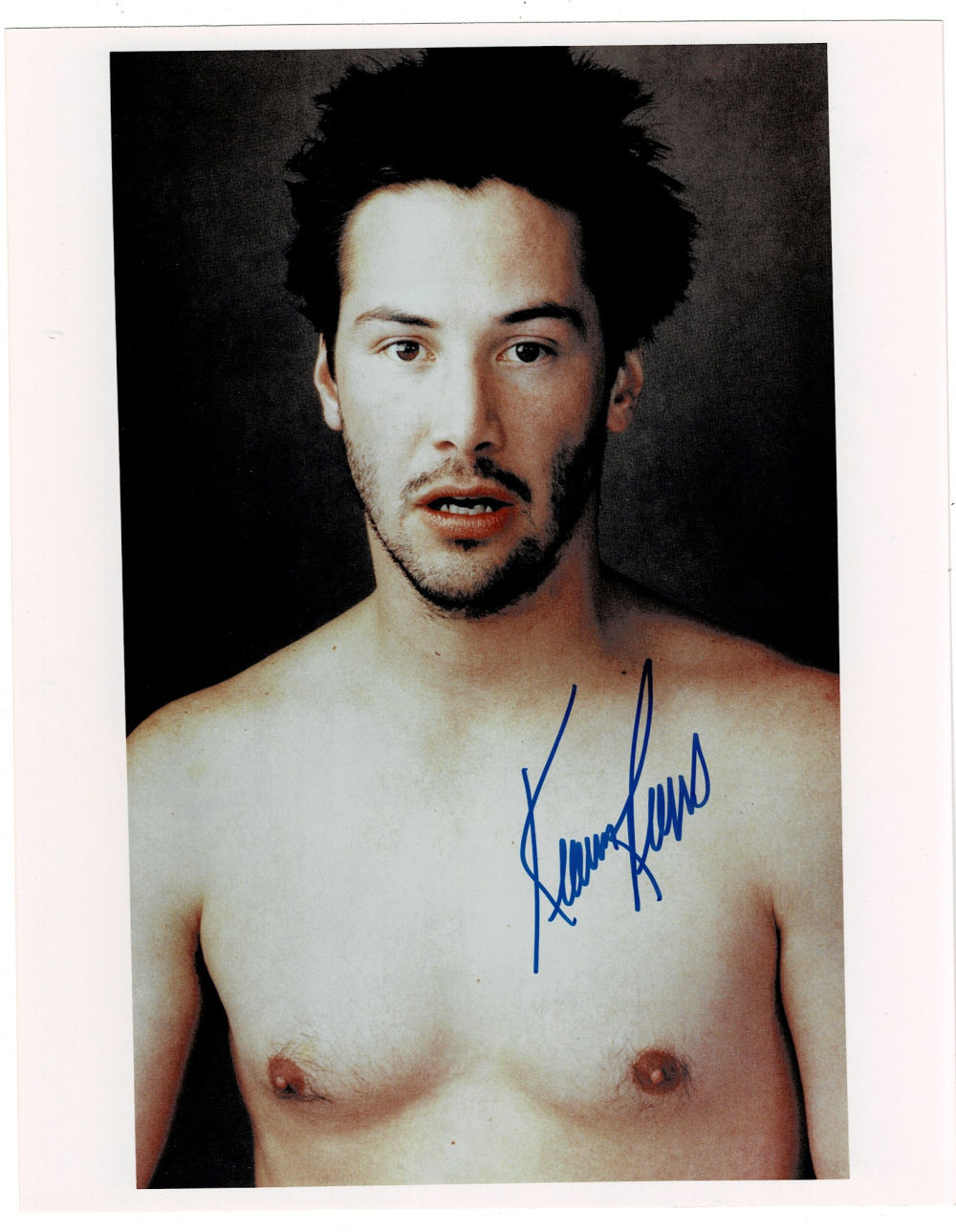 AN ORIGINAL COLOR PHOTOGRAPH of a shirtless KEANU REEVES by ANNIE LEIBOVITZ for Vanity Fair, SIGNED by KEANU REEVES.
